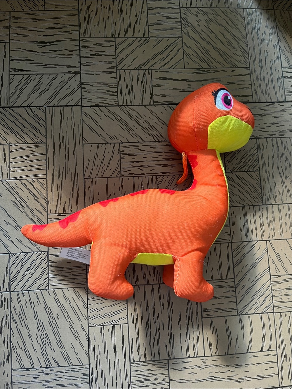 Orange Plush Dinosaur Toy with Yellow Underside